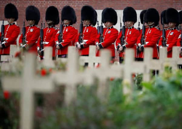 Members of the Irish Guards attend a service to mark the 100th anniversary of the start of the battle of the Somme at the Commonwealth War Graves Commission Memorial in Thiepval, France, where 70,000 British and Commonwealth soldiers with no known grave are commemorated.