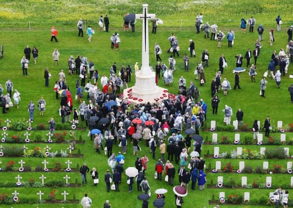 Guests gather at the Cross of Sacrifice following a service to mark the 100th anniversary of the start of the battle of the Somme at the Commonwealth War Graves Commission Memorial in Thiepval, France