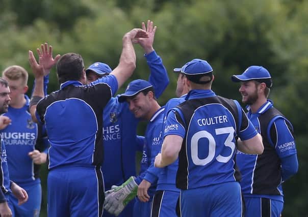 CIYMS celebrate taking a wicket against Carrickfergus