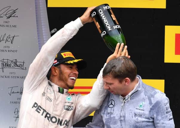 Mercedes driver Lewis Hamilton elebrates his victory with head of Mercedes-Benz Motorsports Toto Wolff