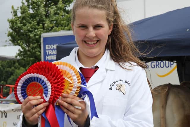 Victoria Johnston displays some of the rosettes won by her family's Ballymacan British Blonde herd. Pictures by Julie Hazelton