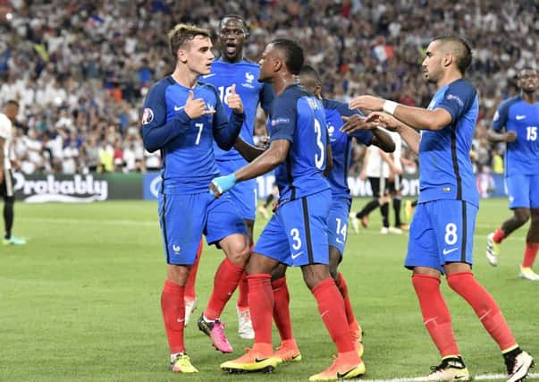 France's Antoine Griezmann, left, celebrates after scoring the opening goal