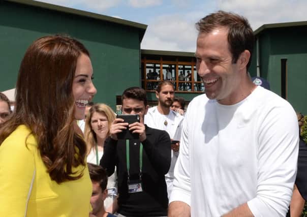 The Duchess of Cambridge meets former tennis player Greg Rusedski during a visit to the Lawn Tennis Championships at the All England Lawn Tennis Club in Wimbledon, London