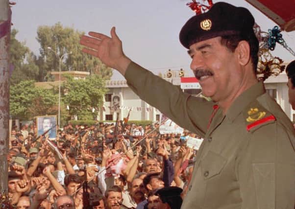 Iraqi President Saddam Hussein waves to supporters in Baghdad, Iraq in this October 18, 1995 a day after being sworn in as president for another seven years  (AP Photo/INA)
