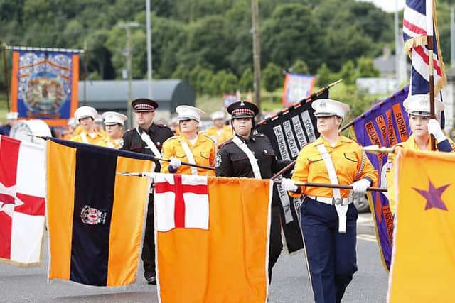 Ballinarrig standards lowered as they pass the War Memorial in Limavady for the 12th July celebrations