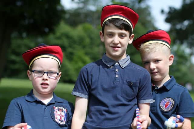 From left,  Lewis Harbinson(7), Kai Galloway(11) and Harry Smith(7) of Crumlin Old Boys Flute Band pictured in Wallace Park before the parade starts