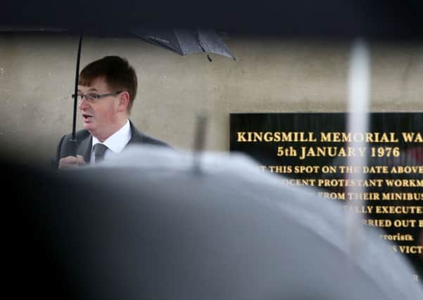 Willie Frazer pictured through a wave of umbrellas in the rain at a memorial service in Co Armagh in January this year, marking the 40th anniversary of the murder of 10 Protestant workmen