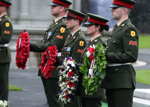 Members of the defence forces hold wreaths during a ceremony to mark the Battle of the Somme Centenary at the Irish National War Memorial Gardens in Islandbridge, Dublin