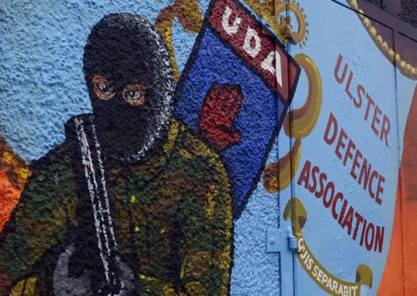 A mural to the UDA South East Antrim branch in Carrickfergus, painted in 2015. The people that put up comparable murals in Belfast could be eligible for a Â£5,000 grant.