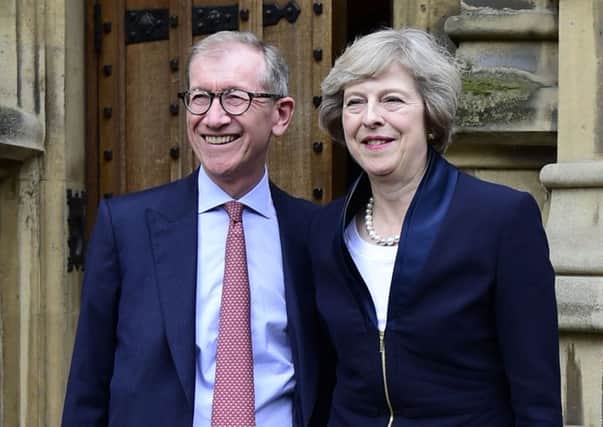 Theresa May with her husband Philip John outside the Houses of Parliament in Westminster, London