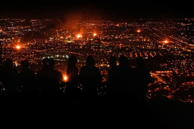Bonfire light up the city from Black Mountain on Monday evening , as the 12th of July celebrations take part across Northern Ireland, to commemorate the Battle of Boyne, which occurred on Ireland's east coast in 1690