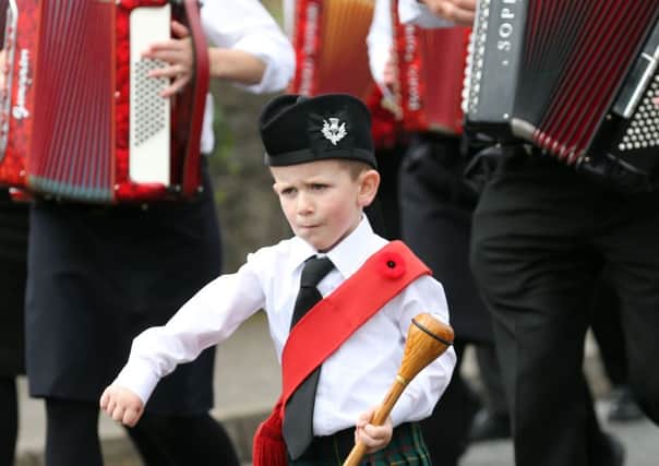 A young bandsman leads the way during Portglenone's 12th of July celebrations.