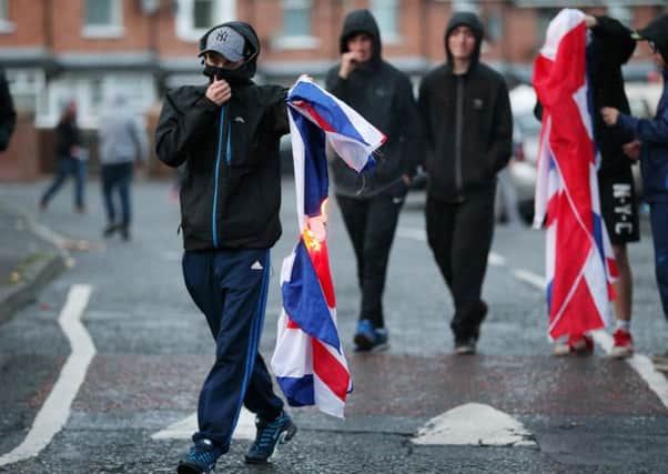 Press Eye - Belfast - Northern Ireland  - 12th July 2016 - 

Nationalist youths try to burn a Union Jack flag at Ardoyne shops in North Belfast after the main 12th of July parades took place across Northern Ireland.

This year, as has been the case since 2013, the feeder parade was not allowed to return by the same route on Tuesday evening.

Photo by Kelvin Boyes / Press Eye.