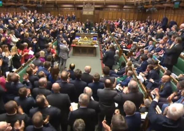 Conservative MPs give Prime Minister David Cameron a standing ovation after finishing his last Prime Minister's Questions in the House of Commons, London