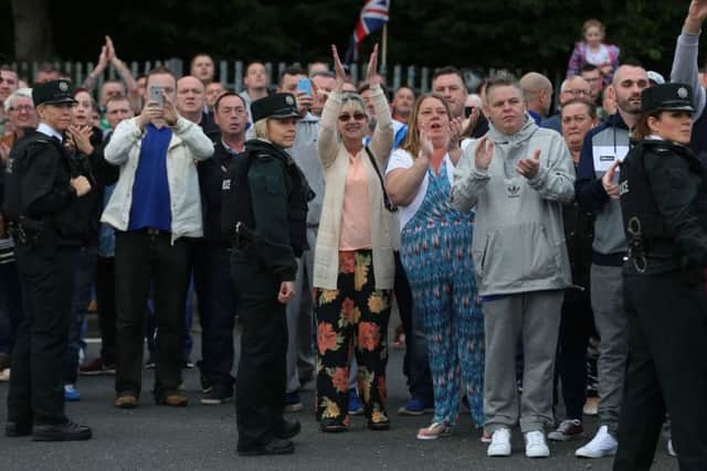 Supporters cheer as members of the Orange Order pass on Crumlin Road, Belfast, as part of the annual Twelfth of July parades across Northern Ireland