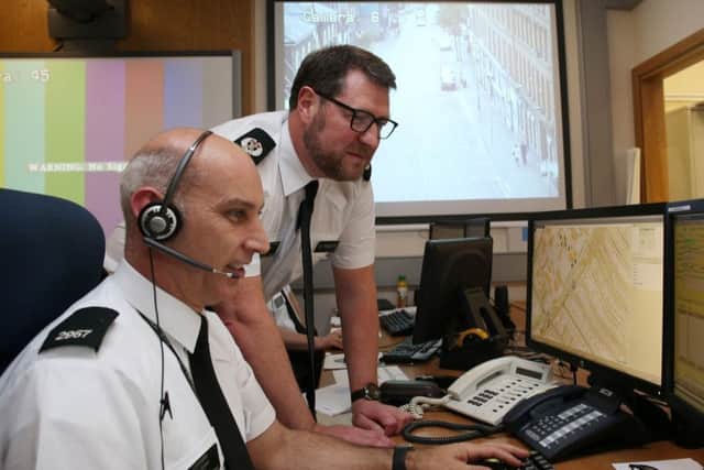 Constable Paul Green speaks with Assistant Chief Constable Stephen Martin (right) of the PSNI in the services Gold Control room in Belfast, who has described the major security operation around the traditional Twelfth of July loyal order parades in Northern Ireland as the most successful in years