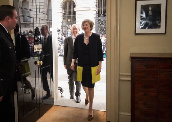New Prime Minister Theresa May, followed by her husband Philip John, walks into 10 Downing Street, London, after meeting Queen Elizabeth II and accepting her invitation to become Prime Minister and form a new government