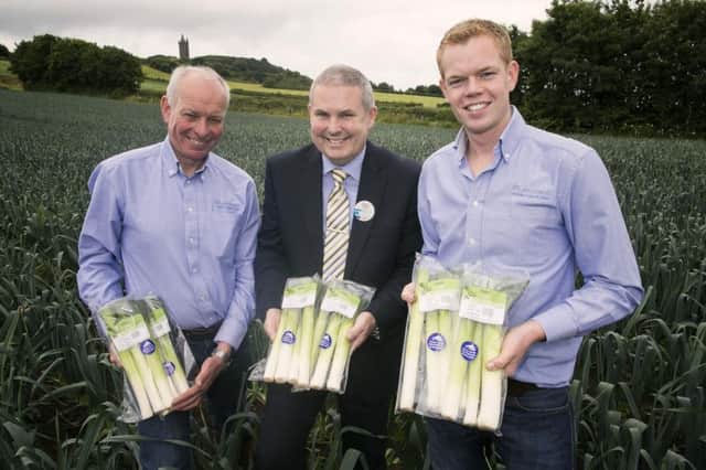 Roy Lyttle pictured with Tony ONeill, manager of the Tesco Newtownards store and his son Alexander at their farm on the Ards Peninsula