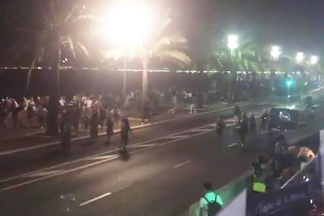 Twitter feed video grab courtesy of  @harp_detectives of people running away after dozens of people are believed to have been killed when a lorry ploughed into a Bastille Day crowd in Nice. Photo credit: @harp_detectives/PA Wire