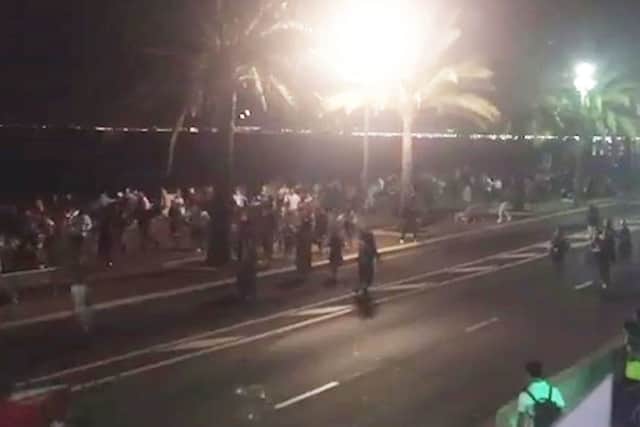 Shocked revellers run away from the scene of the attack on the promenade on Thursday night