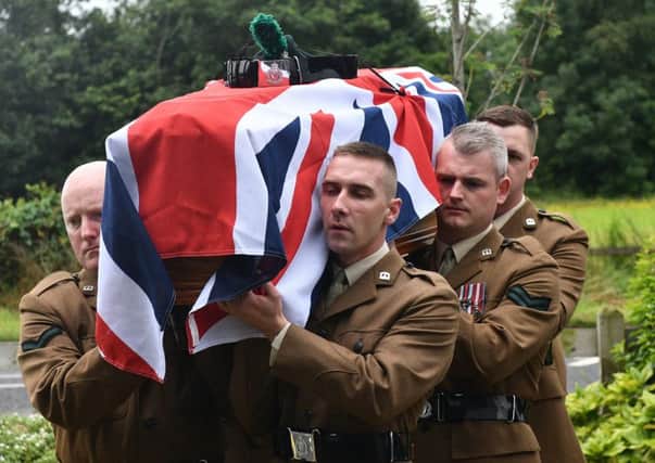 Army colleagues carry Andy McFarland's coffin at his funeral