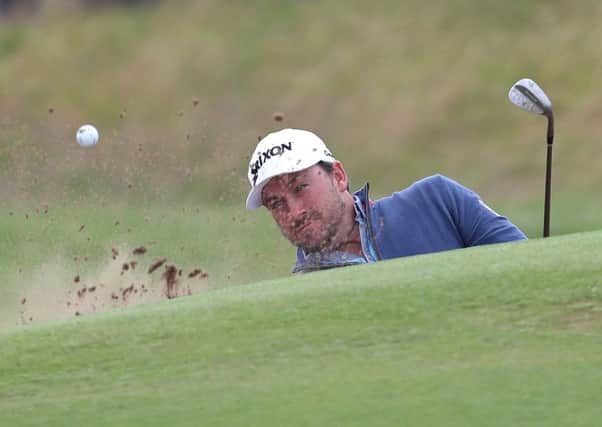 Northern Ireland's Graeme McDowell chips onto the fourth green