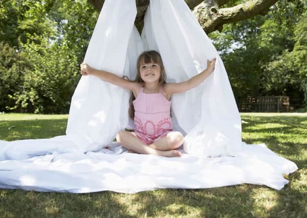A Generic Photo of a young girl sitting in a makeshift den in her garden. See PA Feature GARDENING Children. Picture credit should read: PA Photo/thinkstockphotos. WARNING: This picture must only be used to accompany PA Feature GARDENING Children.