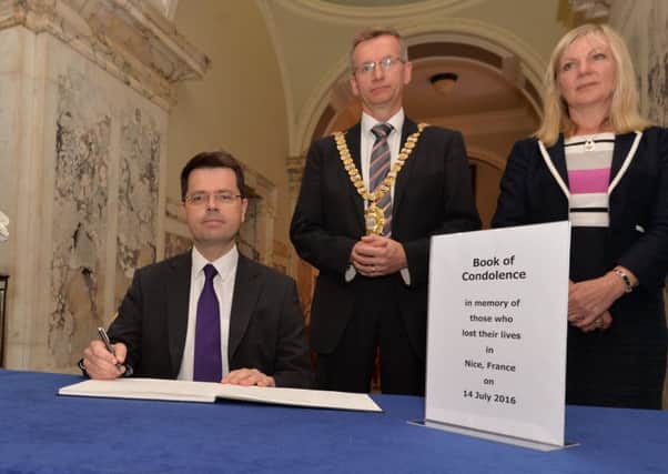 Secretary of State for Northern Ireland James Brokenshire signs the Nice book of condolence in Belfast City Hall with Lord Mayor Brian Kingston and Suzanne Wylie (chief executive of Belfast City Council)