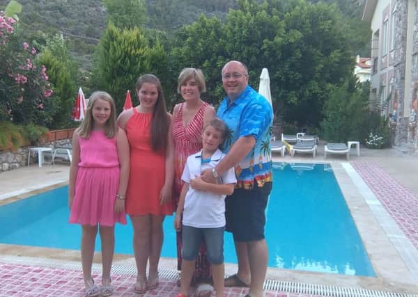 Rev Wille Nixon, Anglican vicar at Drumbeg, with, from left, daughters Alice and Anna, wife Caroline and son Sam at their villa pool in Turunc, Turkey, following the failed military coup at the weekend
