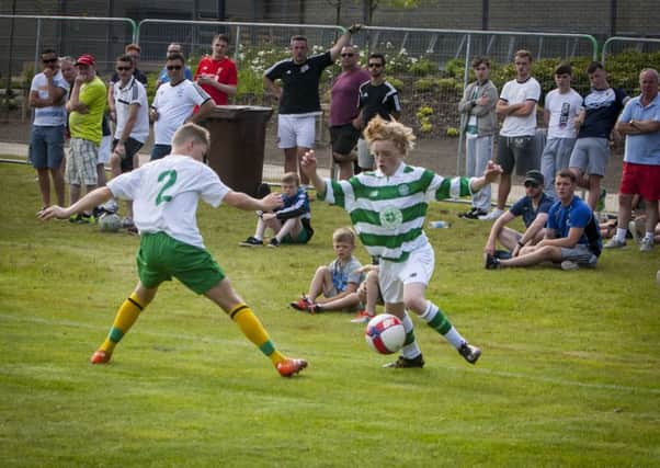 Celtic's diminutive winger Owen Moffatt attempts to get past Donegal Schoolboys' Kieran Tobin during Tuesday evening's Hughes Insurance Foyle Cup game at Brooke Park, Derry. FC02-T2-01