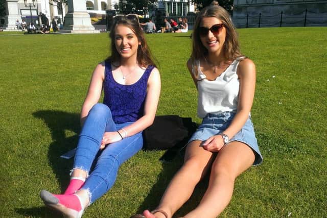 Caitilin Grimley, 18, and Katie McDowell, 18, enjoy the hottest day so far of 2016 in the grounds of Belfast City Hall