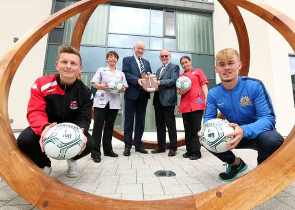 Ross Holden of Crusaders (left), Mark Sykes(Glenavon far right), pictured with Patricia McCabe (NI Hospice  Auxiliary Nurse), Adrian Teer, Chairman NIFL, Sir Bruce Robinson, NI Hospice and Debbie Sharkey, NI Hospice