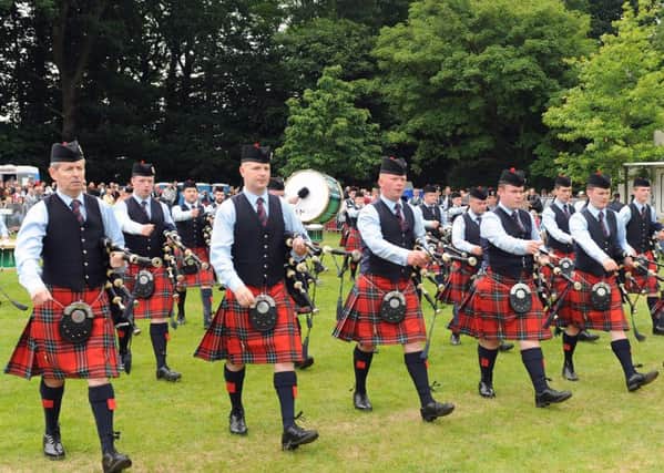 Pipe Major Richard Parkes MBE (left) and Field Marshal Montgomery Pipe Band pictured leaving the competition arena at the Ulster Championships at Antrim Castle Gardens
