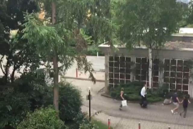 In this frame grab taken from video, people run from the  Olympia Einkaufszentrum shopping centre after a shooting, in Munich, Germany, Friday, July 22, 2016. Munich police confirm shots have been fired at Olympia Einkaufszentrum shopping center but say they don't have any details about casualties.(Thamina Stoll/UGC via AP)