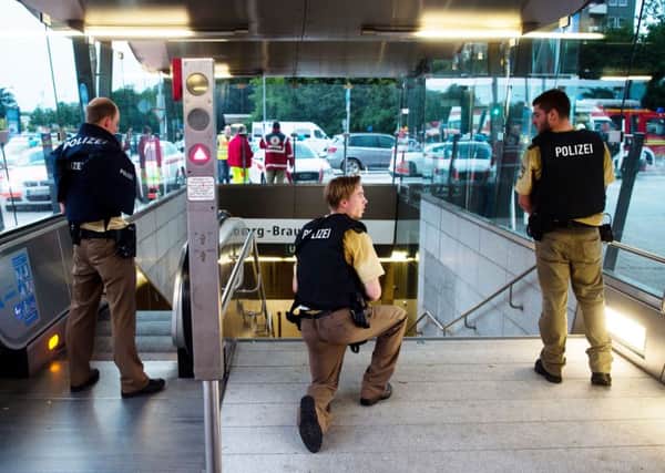Policemen stand at the underground station Georg-Brauchle-Ring close to the Olympia shopping centre in which a shooting was reported in Munich, southern Germany