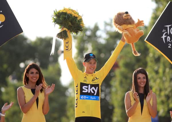 Team Sky's Chris Froome celebrates as he collects the yellow jersey for winning the Tour De France