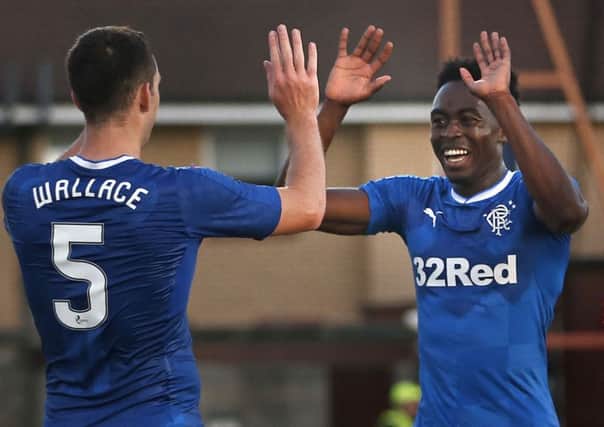 Rangers' Joe Dodoo celebrates scoring his side's third goal with team-mate Lee Wallace during the Betfred Cup, Group F match at Ochilview Park, Stenhousemuir