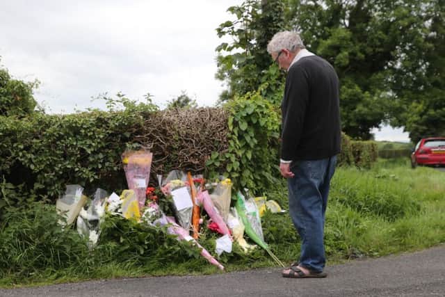 Flowers left at the scene where two care home workers and friends were killed in a car accident in Randalstown yesterday