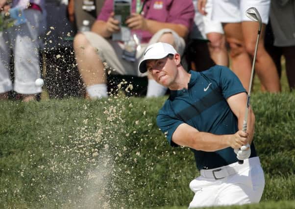 Rory McIlroy hits from a sand trap on the 16th hole during the first round of the PGA Championship.