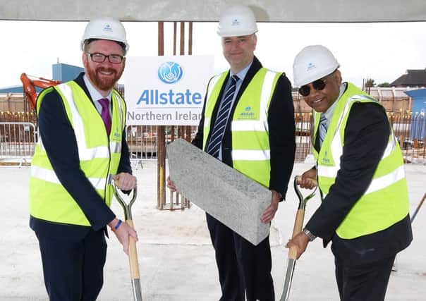 Mr Hamilton pictured at the site with Allstate NI MD John Healy and Executive V-P Suren Gupta