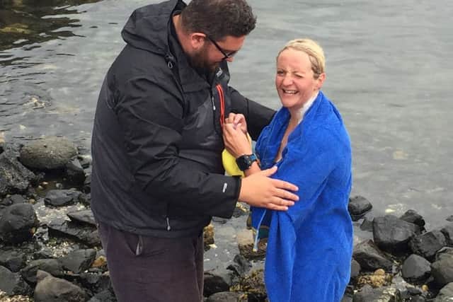Heather Clatworthy is hugged by her husband Ian after landing at Portstewart, who has become the first swimmer in almost 90 years to cross a 13-mile stretch of sea between two coastal beauty spots off Ireland's north coast. Photo: David Young/PA Wire