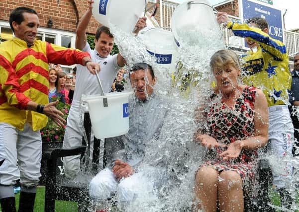 File photo dated 22/8/2014 of Jockey Frankie Dettori and presenter Clare Balding take part in the 'Ice Bucket Challenge' at York Racecourse, York