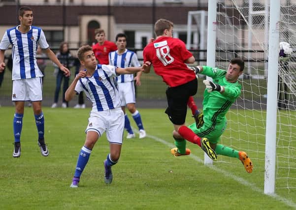 County Antrim's Daniel Reynolds scores the winning goal against  Real Sociedad