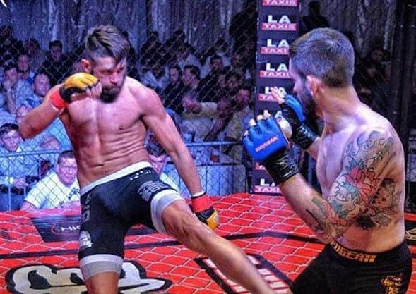 MMA fighter Tommy in action in the ring