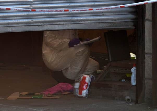 A police forensic investigator at work in the Coalisland garage where the body of Gediminas Stauskas was found