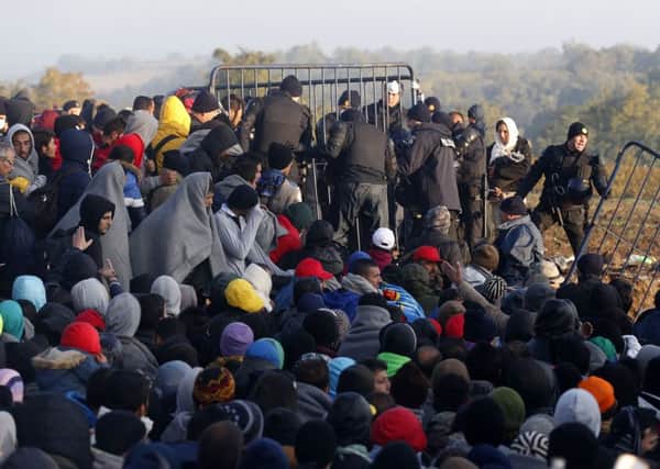 Like the Good Samaritan in the Gospel, Mrs Merkel will not allow Germany to pass by and ignore crushed and broken. Migrants, above, at the border between Serbia and Croatia last year. (AP Photo/Darko Vojinovic)