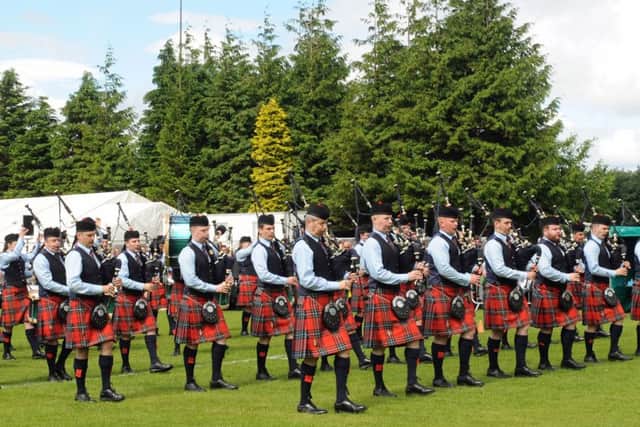 Pipe Major Richard Parkes MBE (left in front row) and Field Marshal Montgomery Pipe Band enter the competition arena at the Scottish Championships