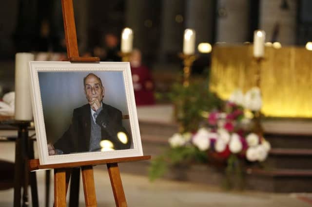 A photo of Father Jacques Hamel is on display during his funeral mass at the Rouen cathedral, Normandy, Tuesday, Aug.2, 2016. Father Jacques Hamel was killed by two Islamic extremists last week in the nearby town of Saint-Etienne-du-Rouvray. The Islamic State group claimed responsibility for the attack. (Charly Triballeau, Pool via AP)