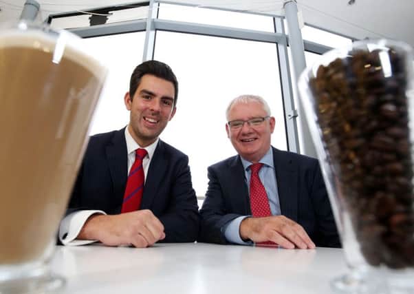 Ryan Kee, director of retail agency at Lambert Smith Hampton, and Gerry Monaghan, manager of Connswater Shopping Centre and Retail Park, celebrate the Starbucks development