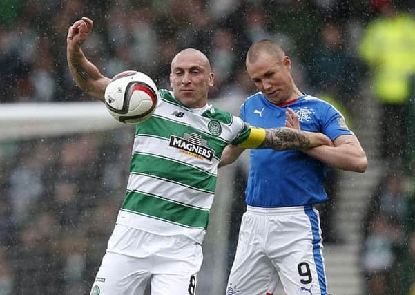 Rangers striker Kenny Miller (right) in action with Celtics Scott Brown